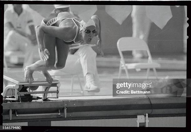 Tracy Caulkins, American swimmer of Nashville, Tennessee, dives into the pool here on her way to a new Olympic record in the 200m individual medley...