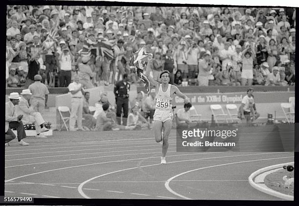 Britain's Sebastian Coe runs along the track here, carrying the flag after winning the Gold Medal in the 1,500 Meter run.