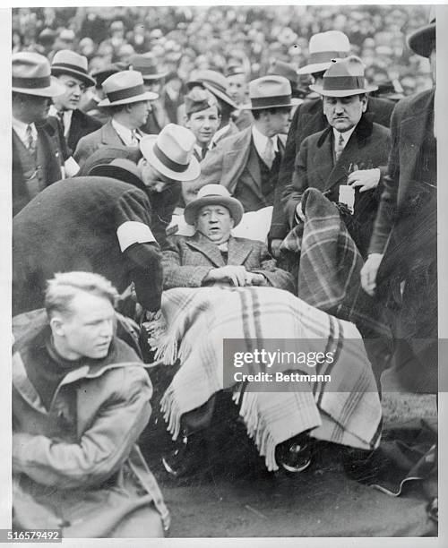 In A wheel chair, Enute Rockne, watches his "Fighting Irish" play the University of Southern California