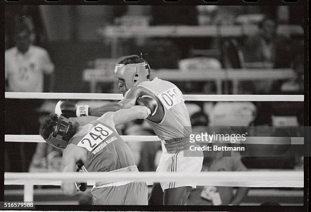 Salulolo Aumua of Western Samoa takes a hard right to the head from Gnohere Sery of the Ivory Coast during Sery's knockout victory 7/31. Amua was...