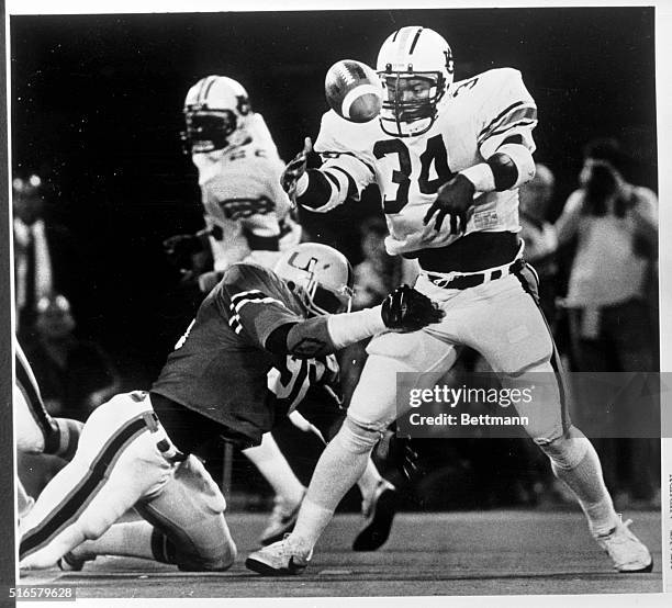 Auburn University's Bo Jackson , bobbles but retains control while being tackled by the University of Miami's, Victor Morris , during the second...