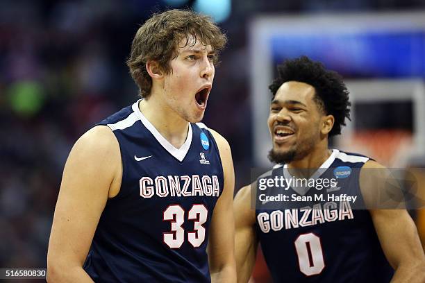 Kyle Wiltjer of the Gonzaga Bulldogs celebrates with teammate Silas Melson in the first half against the Utah Utes during the second round of the...