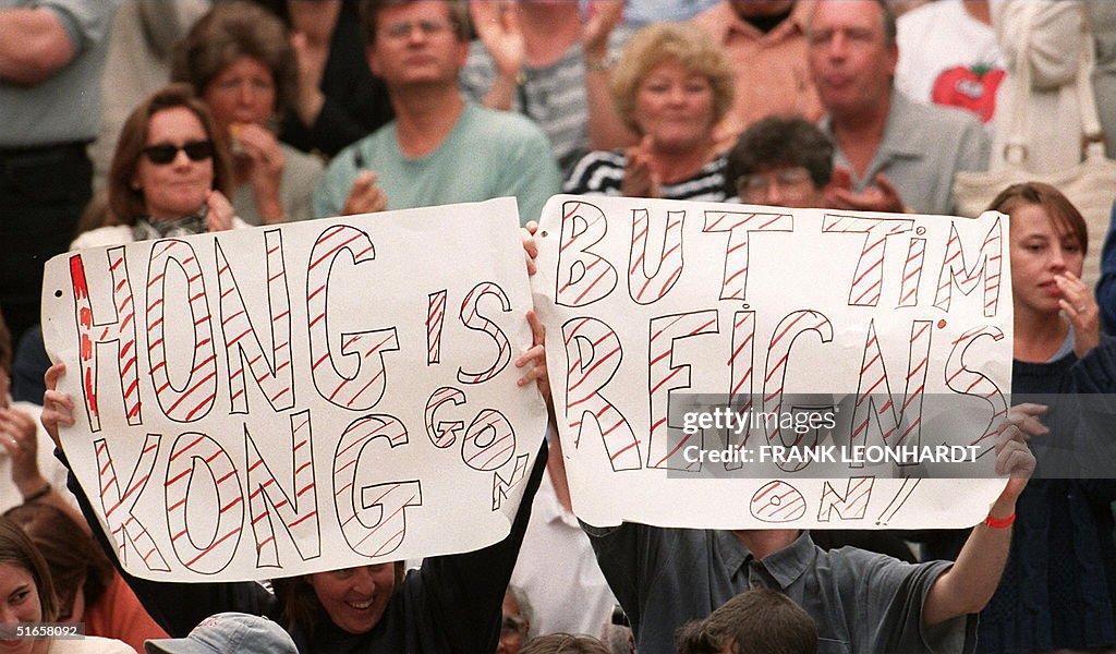 A topical banner is held up by fans of Briton Tim