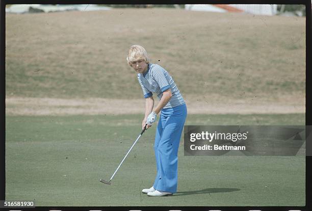 Laura Baugh voted Golfer's Digest most beautiful golfer in 1971, concentrates on her shot.