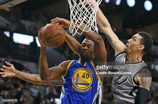 Harrison Barnes of the Golden States Warriors has his shot blocked by Kawhi Leonard of the San Antonio Spurs,not visible, and Danny Green of the San...