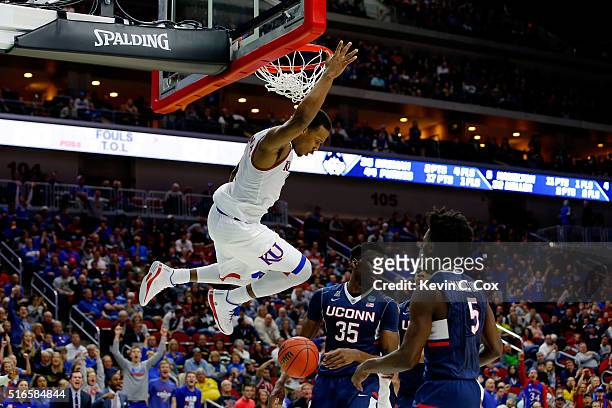 Wayne Selden Jr. #1 of the Kansas Jayhawks dunks over Amida Brimah of the Connecticut Huskies in the second half during the second round of the 2016...