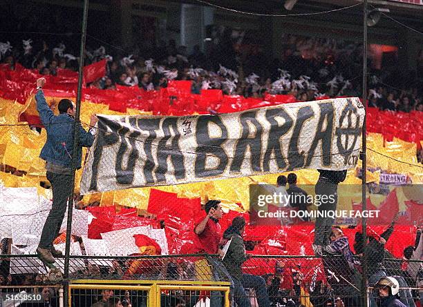 Real madrid ' soccer supporters fix an insulting banderole for Barcelona on a stadium fence during the soccer match of Spanish first division Real...