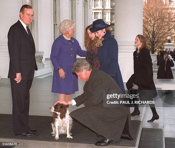 President George Bush in a picture taken 20 January 1993 at the steps of the White House in Washington, DC., watches as US President-elect Bill...