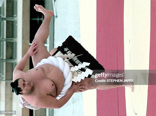 Sumo grand champion Akebono performs a ring-entering ceremony to drive out the evil spirits at Minami Nagano Sports Park at the Opening Ceremony of...
