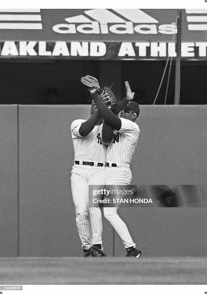 Left fielder Mark Whiten (L) and center fielder Be
