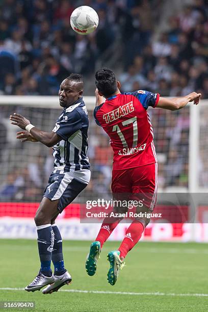 Walter Ayovi of Monterrey heads the ball with Jesus Sanchez of Chivas during the 11th round match between Monterrey and Chivas as part of the...