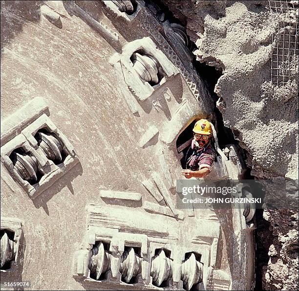Workman emerges from a tunnel boring machine that bore a 25 foot diameter, 5 mile long horseshoe shaped tunnel through Yucca Mountain at the Nevada...