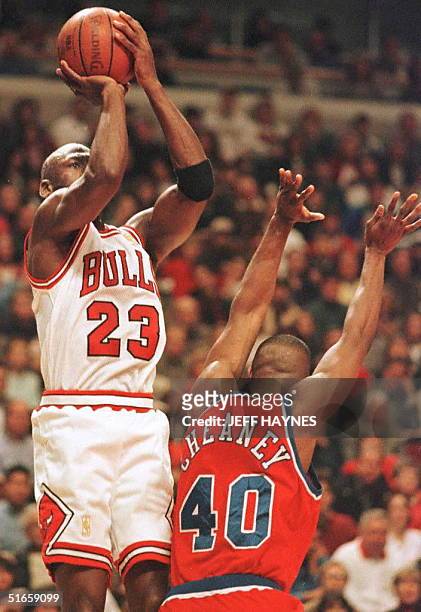 Michael Jordan of the Chicago Bulls shoots over Calbert Chaney of the Washington Bullets 27 April during the first half of game two of their first...