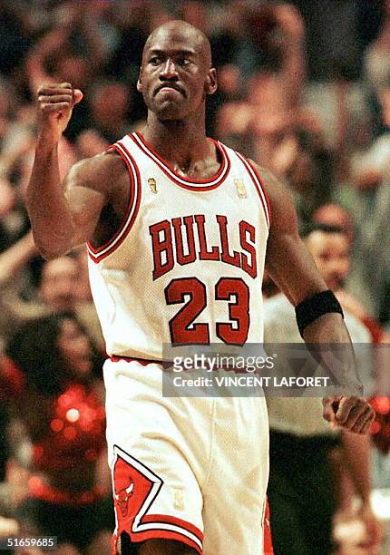 Michael Jordan of the Chicago Bulls pumps his fist after scoring the game winning basket in the fourth quarter 01 June during game one of the NBA...