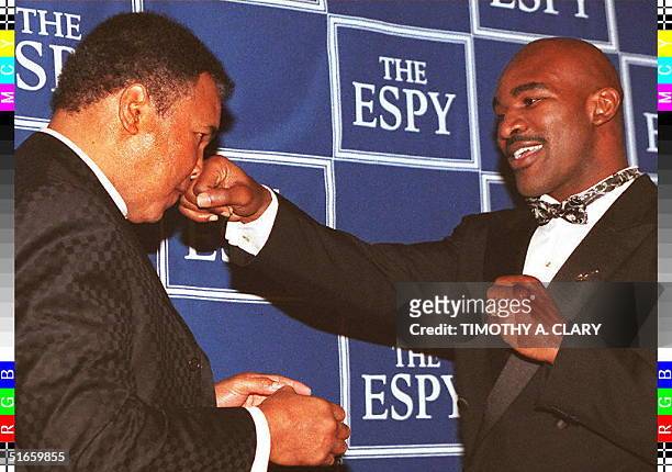 Heavyweight Champions Muhammad Ali and Evander Holyfield play around for the cameras after recieving their ESPY Awards at the 5th Annual ceremony at...