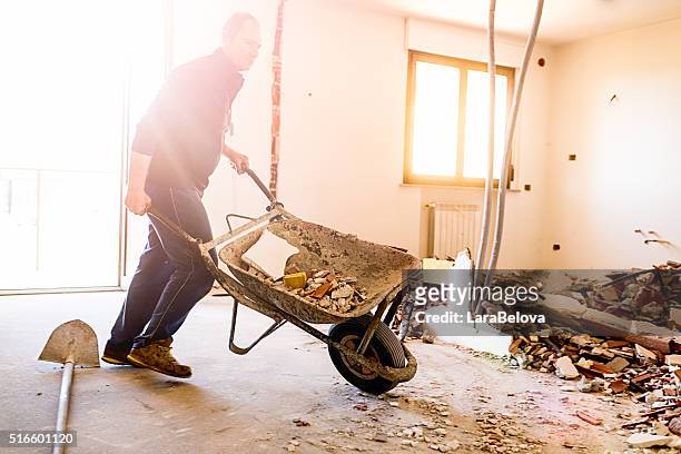 real italian worker repairing apartment - wheelbarrow stock pictures, royalty-free photos & images