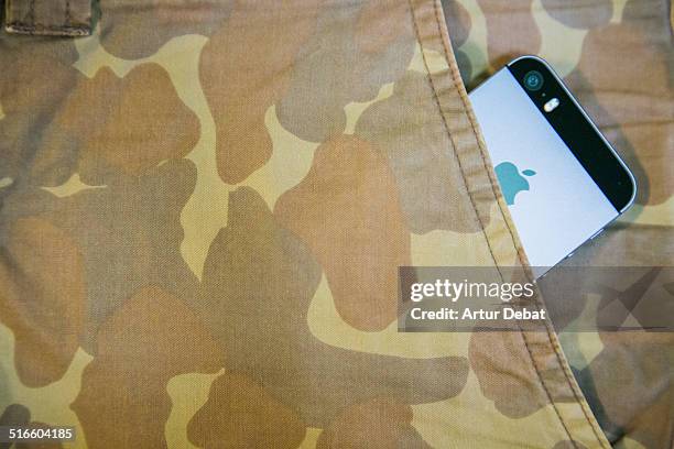 IPhone 5s inside pocket of a camouflage trousers.
