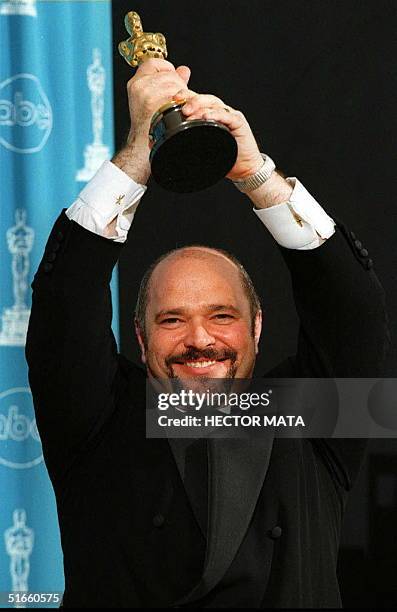British director Anthony Minghella holds his Oscar for his work on the film "The English Patient" during the 69th Annual Academy Awards 24 March in...