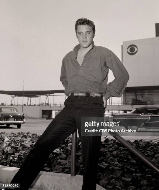 American singer and musician Elvis Presley poses outside CBS Television City, Los Angeles, California. 1956. The was the year of Presley's landmark...