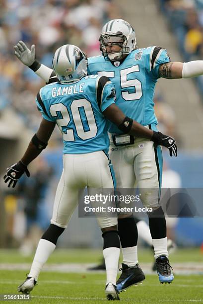 Chris Gamble and Dan Morgan of the Carolina Panthers celebrate a play against the San Diego Chargers on October 24, 2004 at Bank of America Stadium...
