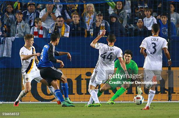 Chris Wondolowski of the San Jose Earthquakes scores late in the second half against goalkeeper Brian Rowe of the Los Angeles Galaxy during the MLS...