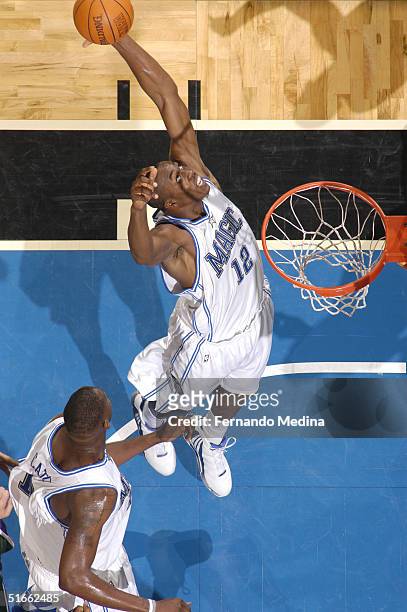 Dwight Howard of the Orlando Magic rebounds against the Milwaukee Bucks during a game at TD Waterhouse Centre on November 3, 2004 in Orlando,...