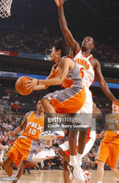 Yuta Tabuse of the Phoenix Suns drives against Royal Ivey of the Atlanta Hawks on November 3, 2004 at America West Arena in Phoenix, Arizona. NOTE TO...