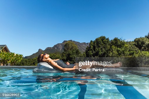 Woman In Inflatable Raft Woman Relaxing On Inflatable Raft In Swimming Pool High-Res Stock Photo ...