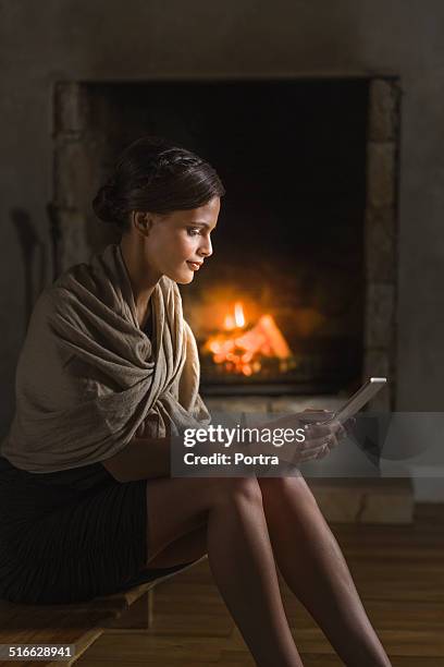 woman using digital tablet in resort - shawl stockfoto's en -beelden