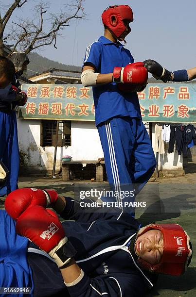 Student grimaces after being knocked down whilst training in the art of Xingyi Quan at the famed Shaolin Monestary in Henan province in central...