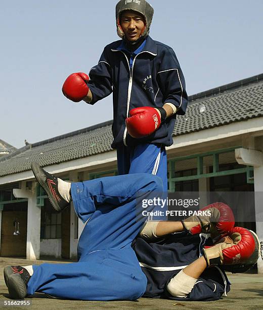 Student training in the art of Xingyi Quan drops his opponant at the famed Shaolin Monestary in Henan province in central China, 03 November 2004....