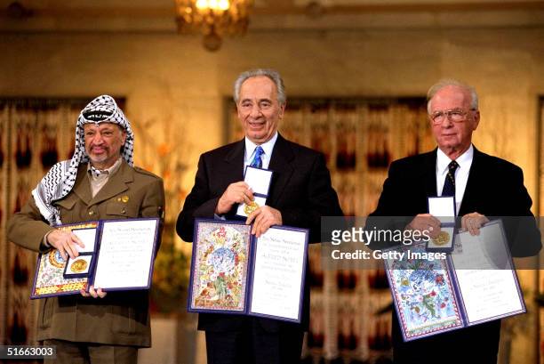 In this handout from the Government Press Office, Israeli Prime Minister Yitzak Rabin, Israeli Foreign Minister Shimon Peres and Palestinian leasder...