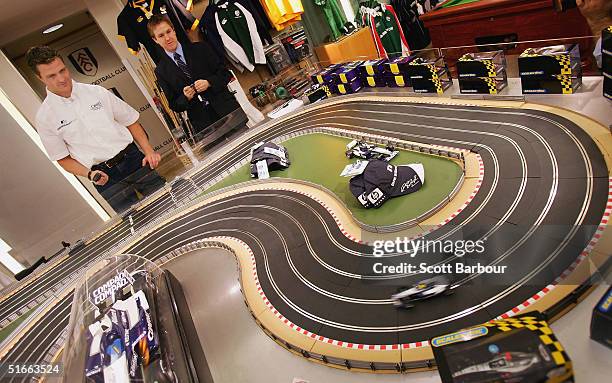 Williams Formula 1 driver Ralf Schumacher of Germany races miniature formula 1 cars during a visit to Harrods Department Store to advertise Swiss...