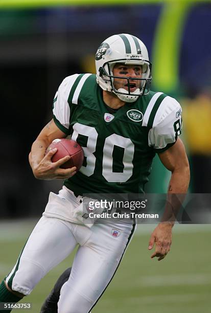 Wide receiver Wayne Chrebet of the New York Jets runs with the ball during a game against the San Francisco 49ers at Giants Stadium on October 17,...