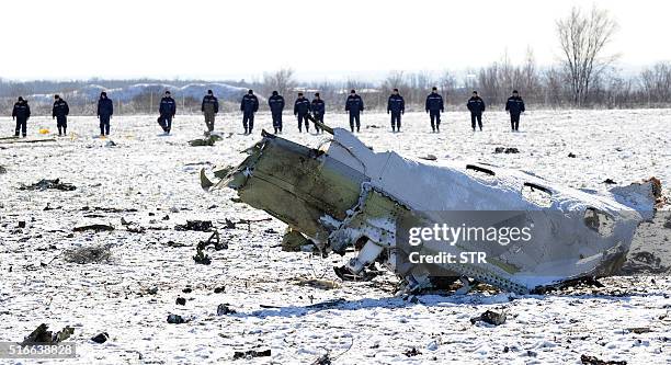 Russian Emergency Ministry rescuers search the wreckage of a crashed airplane at the Rostov-on-Don airport on March 20, 2016. A flydubai passenger...