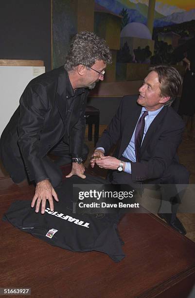 Eddie Jordan with actor Michael Douglas at the CLIC Charity Auction hosted by Eddie and Marie Jordan at Christie's on 22nd October 2001, in London. .