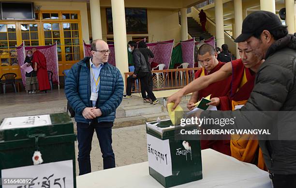 French Senator Andre Gattolin looks on as exiled Tibetans cast their votes to elect a Sikyong of the Central Tibetan Administration and members of...