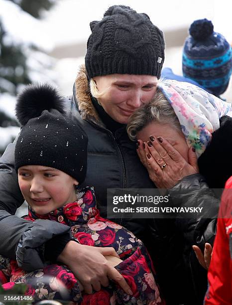 Women cry as they pay a tribute to victims of an air-crash at the Rostov-on-Don airport entrance on March 20, 2016. A flydubai passenger Boeing jet...