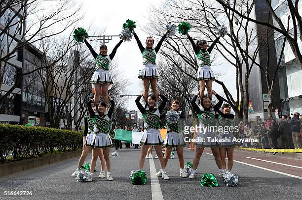 Participants perform on the Omotesando Avenue during the 24th annual St. Patrick's Day Parade on March 20, 2016 in Tokyo, Japan. According to the...