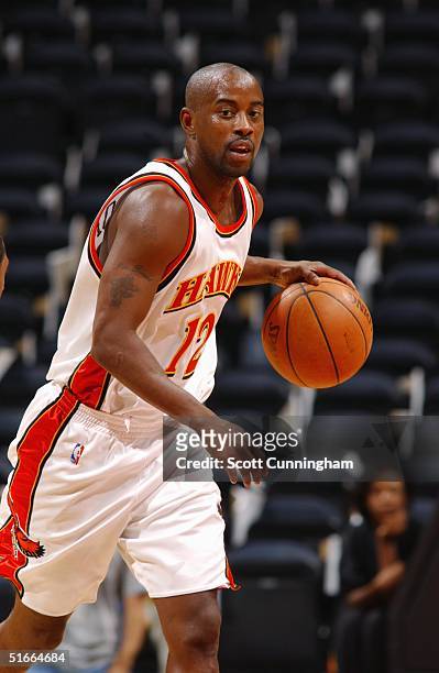 Kenny Anderson of the Atlanta Hawks dribbles upcourt against the Memphis Grizzlies during the preseason game on October 20, 2004 at Philips Arena in...