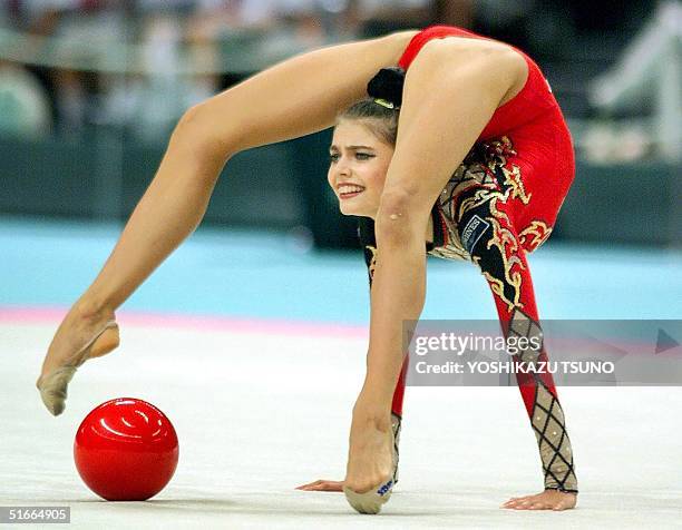 European champion Alina Kabaeva of Russia strikes pose with the ball during the final of the individual all-around competition of the World Rythmic...