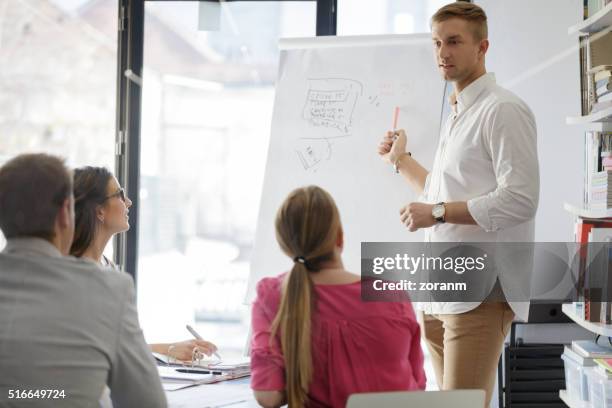 group of business people on a meeting - flipchart stock pictures, royalty-free photos & images