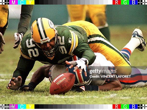 Green Bay Packers defensive end Reggie White jumps over Denver Broncos tight end Shannon Sharpe to recover a fumble by Bronco's quarterback Bill...