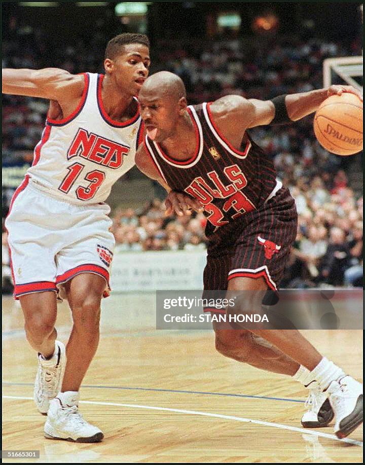 Michael Jordan (R) of the Chicago Bulls drives tow