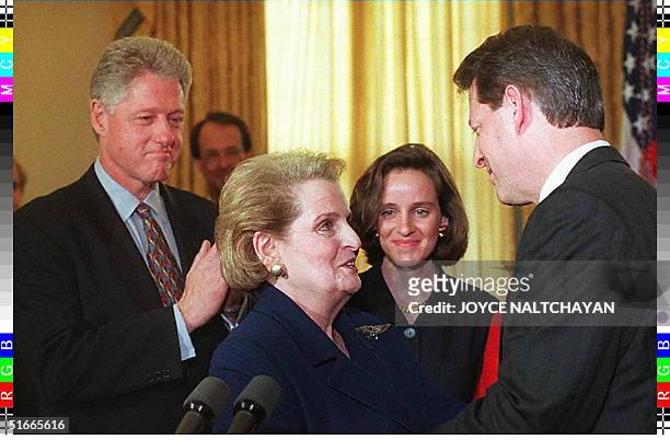 Former UN Ambassador Madeleine Albright is congratulated by US Vice President Al Gore as US President Bill Clinton and Albright's daughter Katie look...