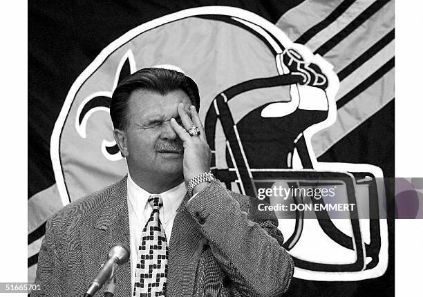Former Chicago Bears coach and Football Hall of Fame member Mike Ditka wipes his face as he answers questions from reporters where he was introduced...