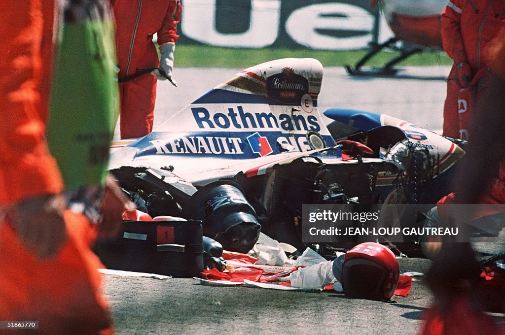 Security surrounds the crashed car of Ayrton Senna