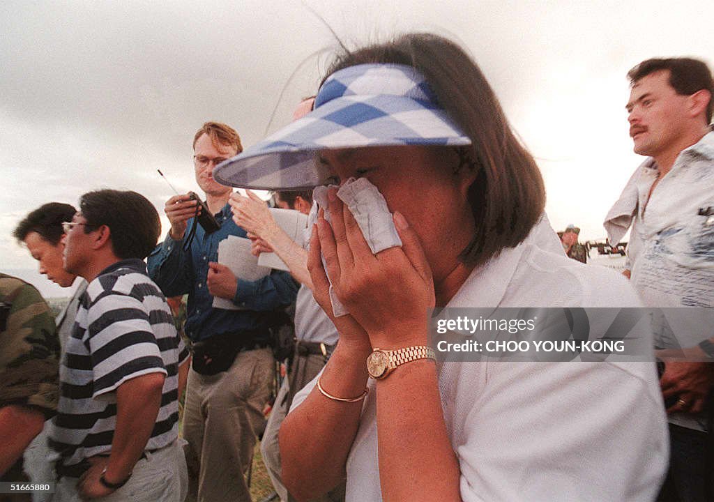 Cho Kuy-Yong, 29-years-old, cries following the de