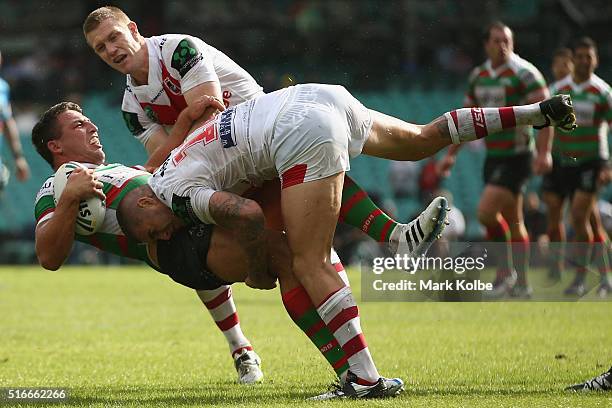 Sam Burgess of the Rabbitohs is tackled by Ben Creagh and Joel Thompson of the Dragons during the round three NRL match between the St George Dragons...