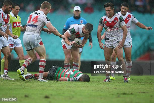 Ben Creagh, Josh McCrone, Mitch Rein and Gareth Widdop of the Dragons looks with concern as Damien Cook of the Rabbitohs lies injured on the ground...